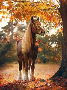 Diamond painting of a majestic brown horse with a flowing mane standing in a colorful autumn forest.