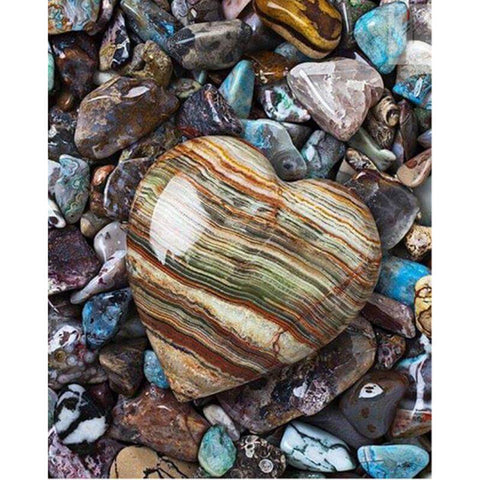 Image of Diamond art featuring a heart-shaped stone amidst a collection of pebbles.