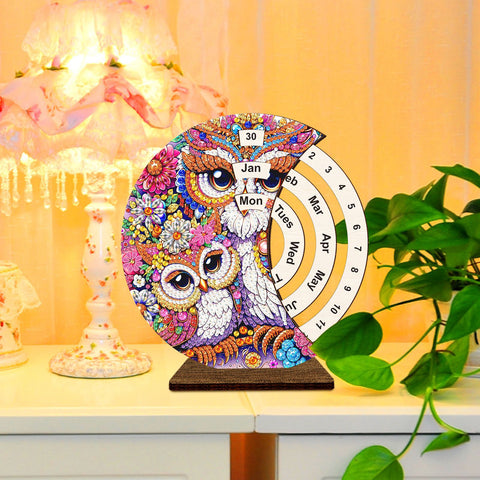 Image of Rotating diamond painting calendar featuring an owl design, wooden base, with month and day indicators, DIY craft for monthly planning