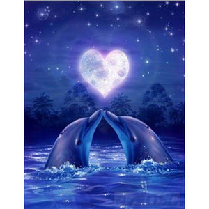 Diamond painting of two dolphins in love, kissing under a heart-shaped moon.