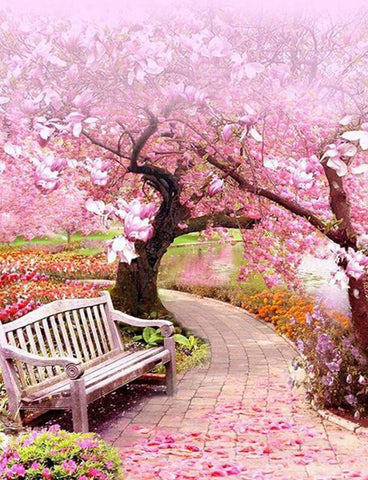 Image of Diamond painting of a park bench under a cherry blossom tree.