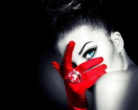 Image of Red and black diamond painting portrait of a lady with red gloves and blue eyes.