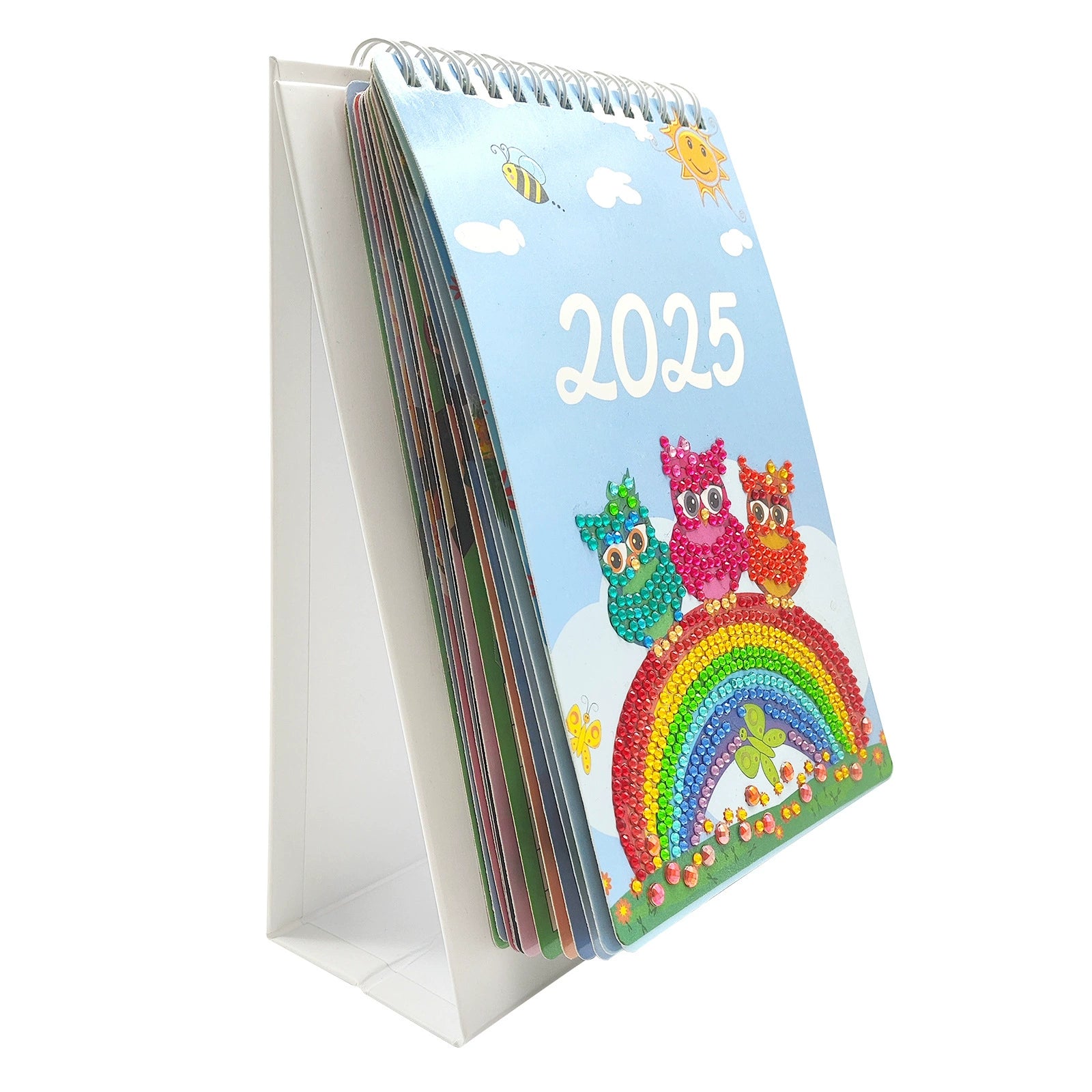 Close-up view of a 2025 diamond painting calendar featuring an owl and rainbow design, showing spiral binding and completed diamond art details