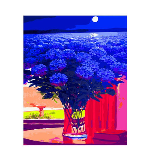 Image of Diamond painting of a vase filled with blue hydrangeas, with a seascape and a full moon in the background.