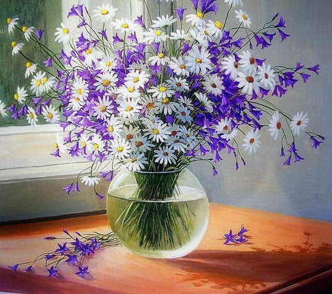 Image of A vase filled with a vibrant bouquet of white daisies and purple bellflowers, bathed in sunlight near a window.