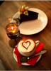 Diamond painting of a cup of coffee with a heart-shaped design, a slice of cake, and a candle