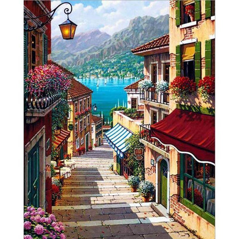 Image of Diamond painting of a picturesque coastal town with cobblestone streets, colorful buildings, and a view of the sea.