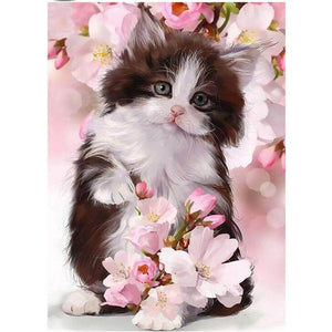 Diamond painting of a cute kitten surrounded by pink cherry blossoms.