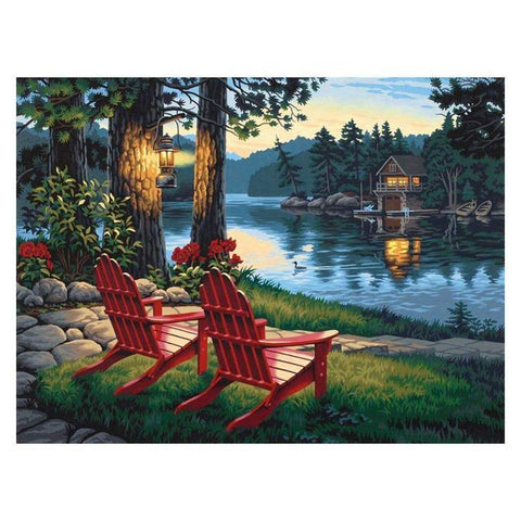 Image of Diamond painting kit featuring a cozy cabin nestled near a lake with majestic mountains in the background.