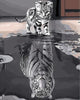 Diamond painting of a cat looking at its reflection, which appears as a tiger, in water.