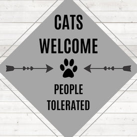 Diamond painting of a sign that says "Cats Welcome, People Tolerated," with a paw print and arrows.