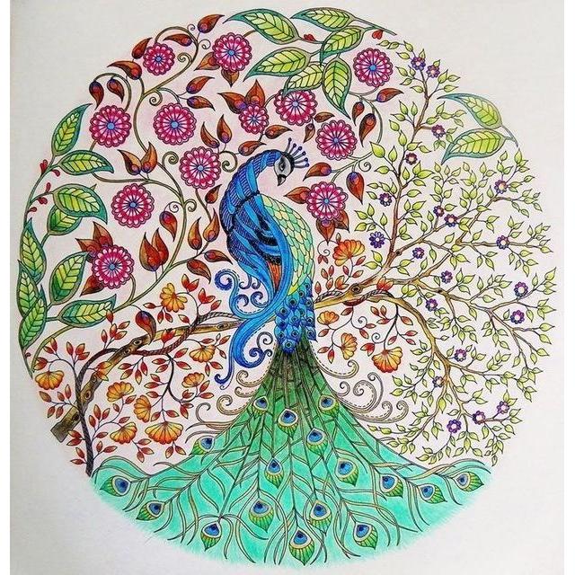 Diamond painting of a peacock in the center of a circular mandala, surrounded by flowers and intricate patterns.