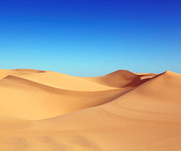 Diamond painting of a vast desert landscape with rolling sand dunes under a bright blue sky