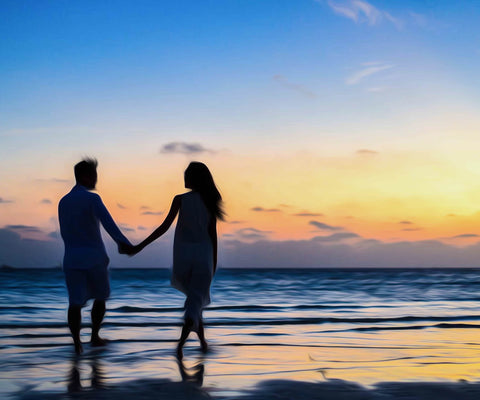 Image of diamond painting of a couple holding hands on a beach at sunset