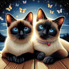 Sparkling diamond art featuring two Siamese cats curled up together.