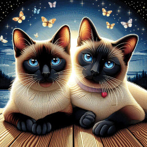 Sparkling diamond art featuring two Siamese cats curled up together.