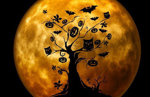 Image of diamond painting of a spooky tree with bats and pumpkins on a full moon