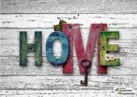 Image of diamond painting of the word "HOME" spelled out with colorful letters and a key