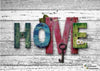 diamond painting of the word "HOME" spelled out with colorful letters and a key