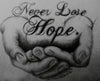 diamond painting of hands holding the words "Never Lose Hope"