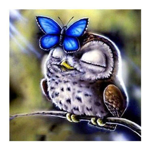 Image of Diamond painting of an owl with brown and white feathers, perched on a tree branch with a colorful butterfly on its head.