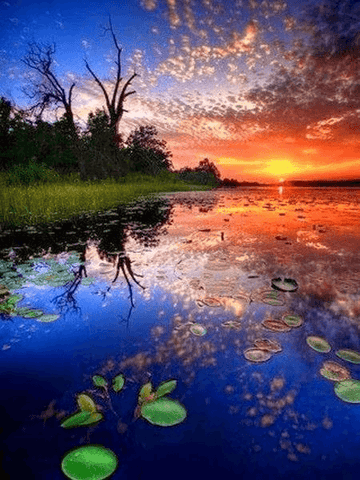 Image of diamond painting of a sunset reflected in a lake