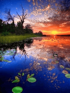 diamond painting of a sunset reflected in a lake