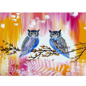 Diamond painting of two owls together on a tree branch 