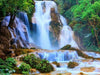 Sparkling diamond art depicting a cascading waterfall surrounded by vibrant green jungle plants. 