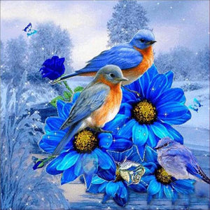 Diamond painting kit featuring a pair of Eastern Bluebirds perched on colorful wildflowers