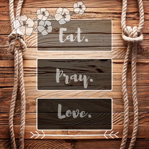 Image of Diamond painting of the quote "Eat. Pray. Love." on a wooden background with rope and floral accents