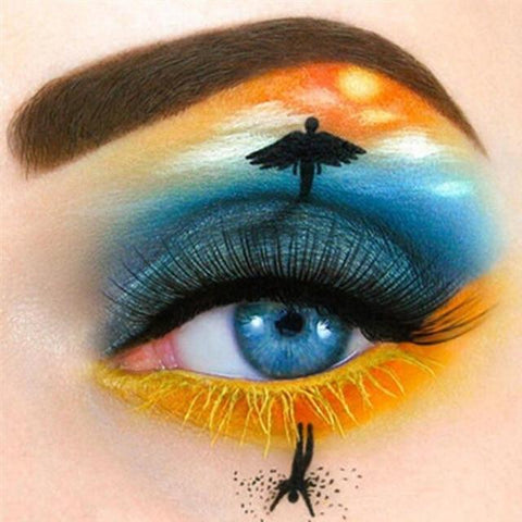 Image of Diamond painting of a creative eye makeup design depicting a sunset, a skydiver, and a sea. It symbolizes faith and hope.