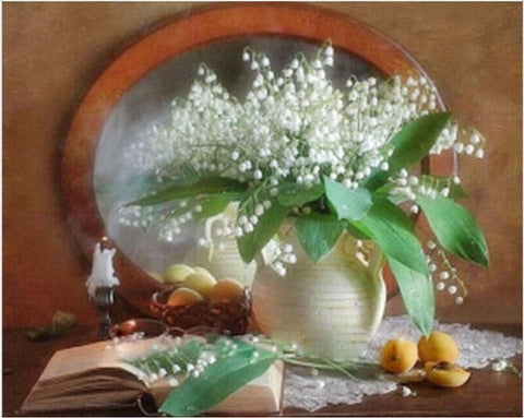 Image of Diamond painting of lilies of the valley in a vase on a table with a book and candle