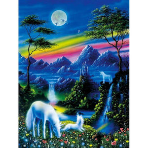 Diamond painting: unicorns standing in a magical forest with mountains in the background.