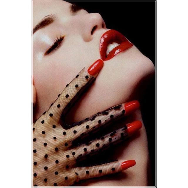 A diamond painting of a woman's face with red lipstick and a gloved hand, creating a glamorous and mysterious look.