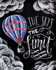 Diamond painting of a hot air balloon floating in the sky with the inspirational quote "The sky's the limit" written in chalkboard style.