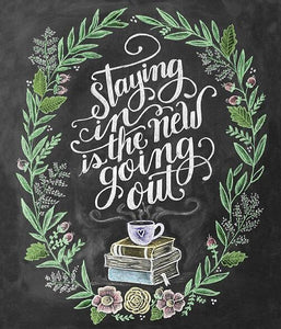 Diamond painting of a chalkboard with a quote that says "Staying in is the new going out," surrounded by books and flowers.