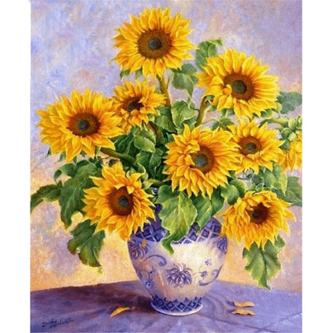 Image of Vibrant diamond painting of a bouquet of sunflowers in a blue and white porcelain vase, with a soft pastel background.