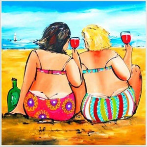 Diamond painting of two women enjoying drinks on a beach.