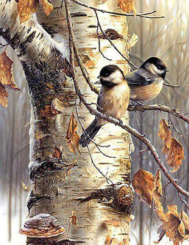 Image of Winter diamond painting depicting two chickadees perched on a snowy branch.