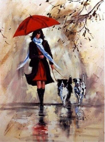 Image of A woman walking her dogs on a rainy day.