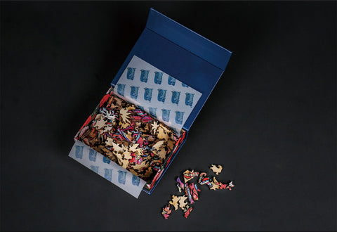 Image of Wooden Jigsaw Puzzle Pieces Scattered from Open Box