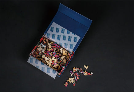 Wooden Jigsaw Puzzle Pieces Scattered from Open Box